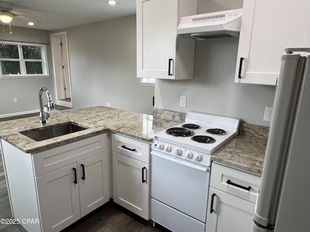 kitchen with white cabinets, white appliances, sink, and range hood