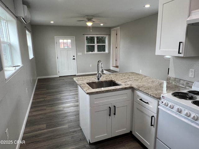 kitchen featuring white range with electric stovetop, white cabinetry, sink, and light stone counters