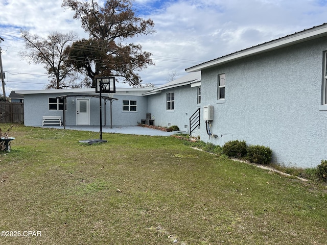 rear view of house featuring a patio area and a lawn