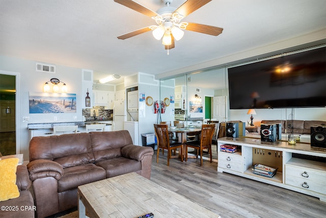 living room featuring light hardwood / wood-style floors and ceiling fan