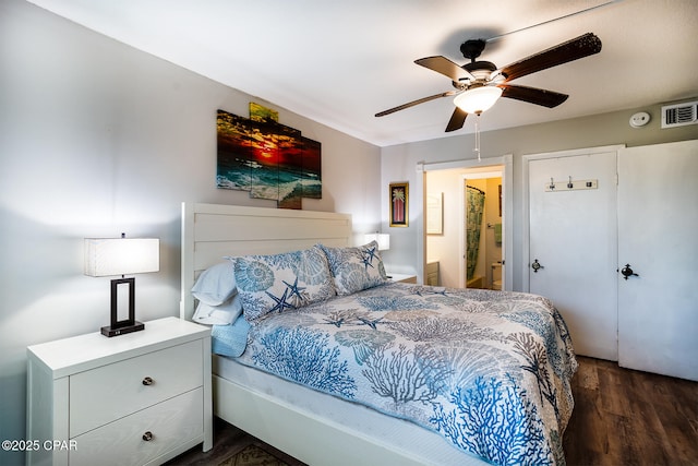 bedroom featuring ceiling fan, ensuite bathroom, and dark hardwood / wood-style floors