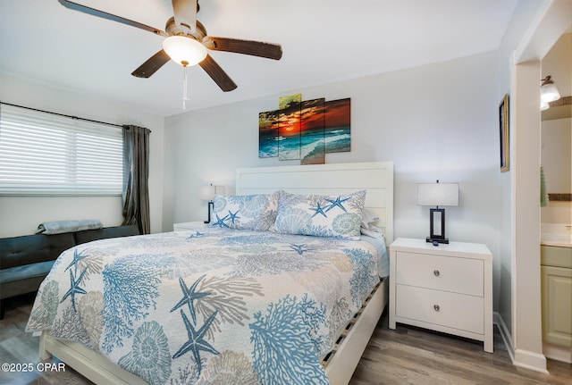 bedroom with hardwood / wood-style floors, ceiling fan, and ensuite bathroom