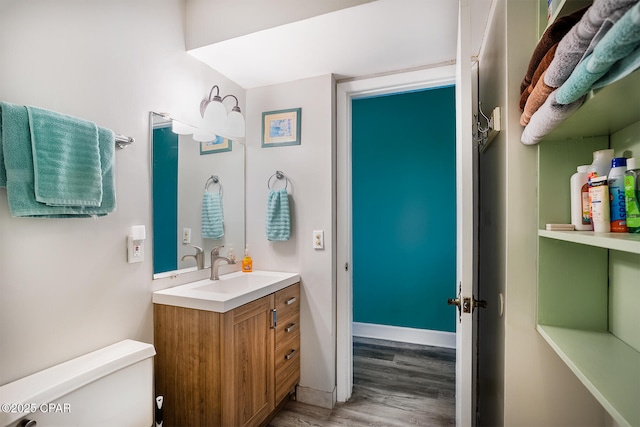 bathroom featuring hardwood / wood-style floors, vanity, and toilet