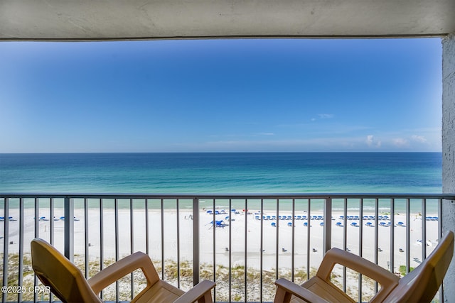 balcony with a view of the beach and a water view