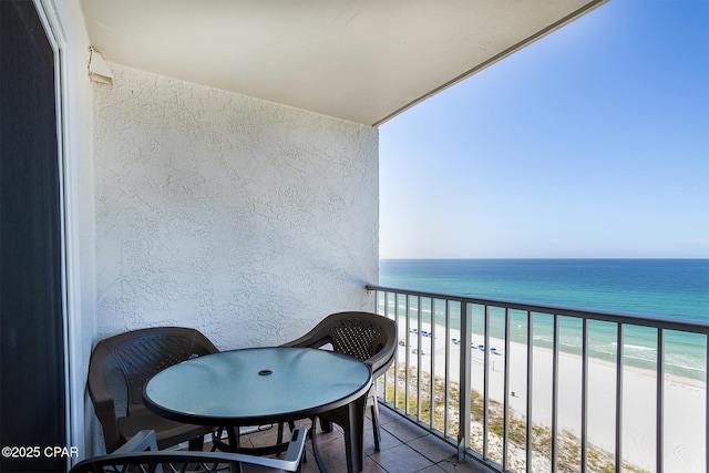 balcony with a water view and a beach view