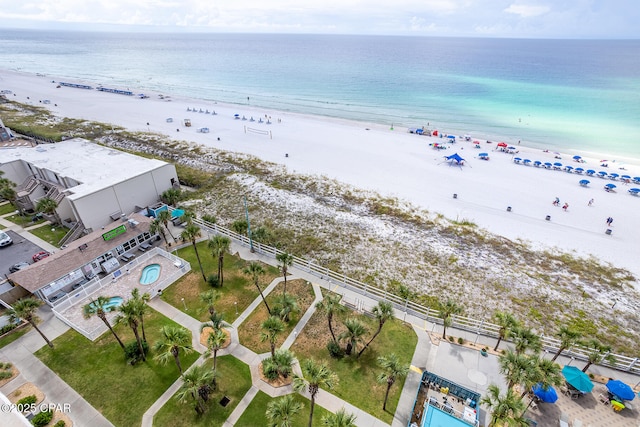 aerial view with a water view and a beach view