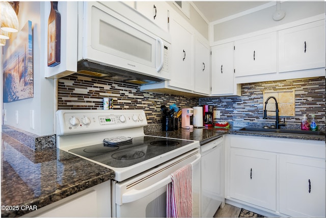 kitchen featuring white appliances, tasteful backsplash, white cabinetry, and sink