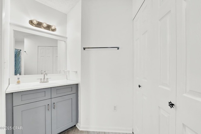 bathroom with vanity and a textured ceiling