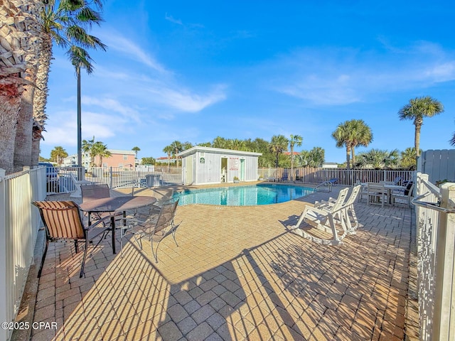 view of swimming pool with a patio area and an outdoor structure