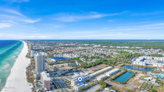 birds eye view of property with a water view and a beach view