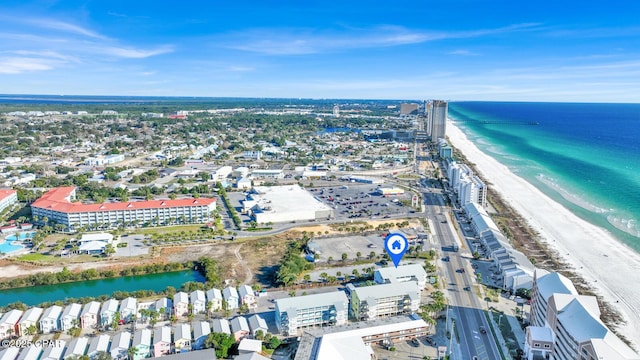 drone / aerial view featuring a water view and a view of the beach