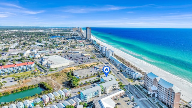 drone / aerial view featuring a water view and a beach view