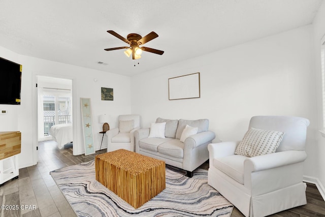 living room with ceiling fan and wood-type flooring