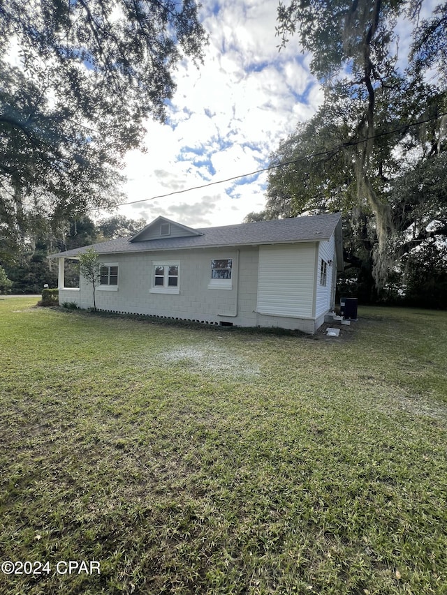 back of property with a lawn