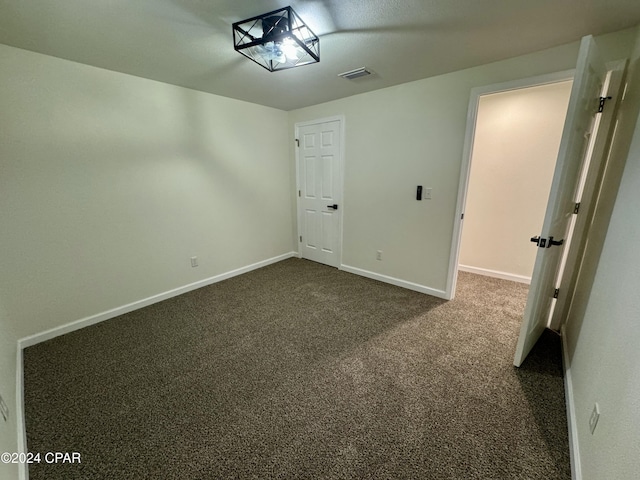 unfurnished bedroom featuring dark colored carpet