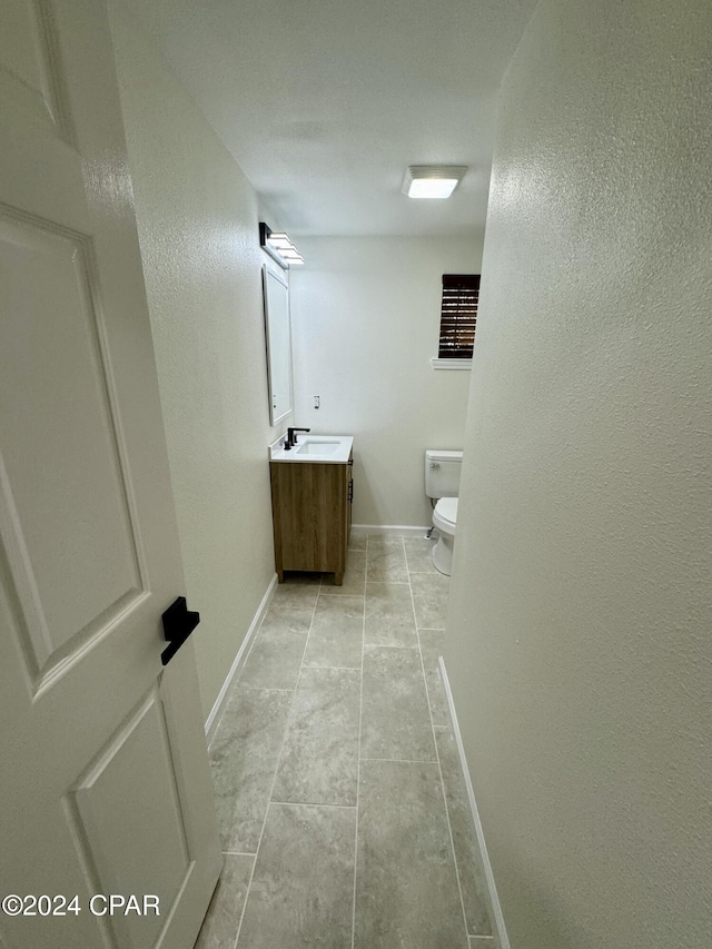 bathroom featuring toilet and vanity