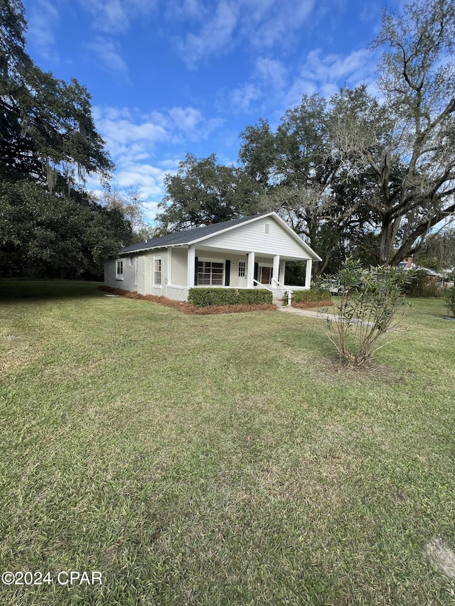 exterior space with a front yard and covered porch