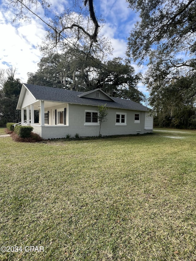 view of side of property with a yard