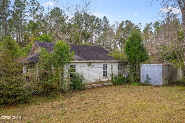 back of house with a lawn