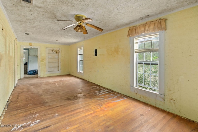 unfurnished room featuring wood-type flooring and ceiling fan with notable chandelier