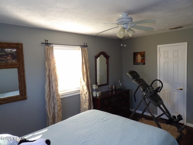 bedroom featuring a textured ceiling and ceiling fan