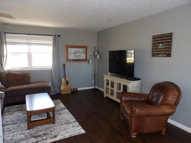 living room featuring a textured ceiling and dark hardwood / wood-style floors