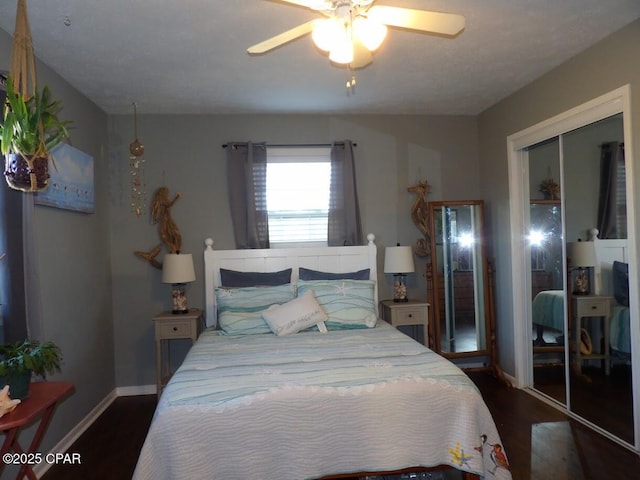 bedroom with dark hardwood / wood-style flooring, a closet, and ceiling fan