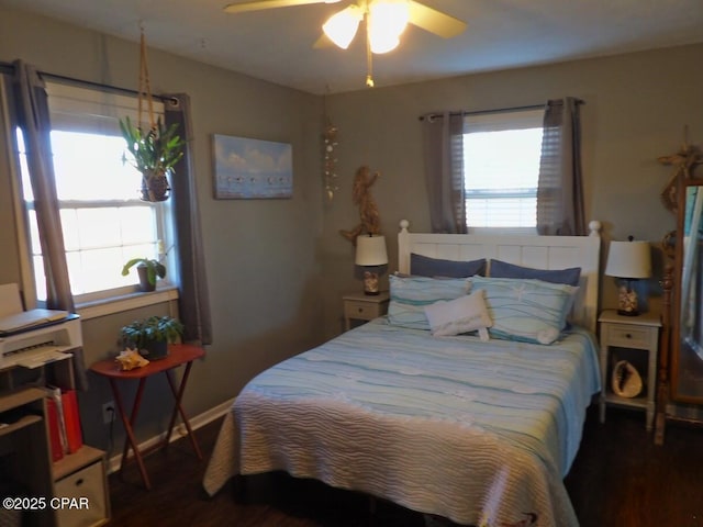 bedroom with multiple windows, ceiling fan, and dark hardwood / wood-style floors