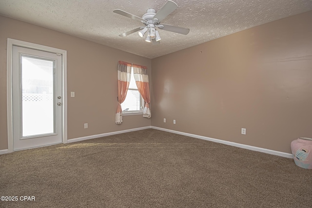 empty room with ceiling fan, carpet, and a textured ceiling