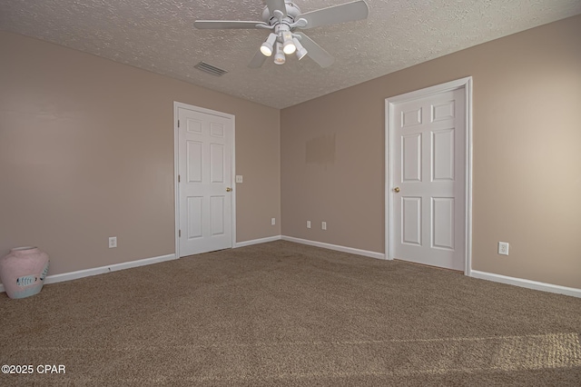 carpeted spare room with ceiling fan and a textured ceiling