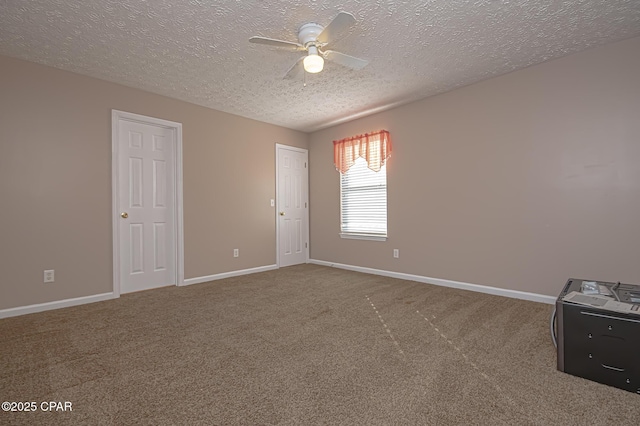 carpeted spare room with a textured ceiling, baseboards, and ceiling fan