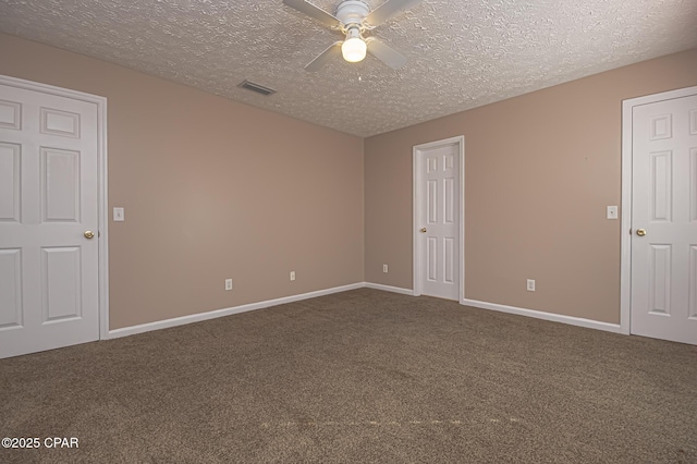 empty room with visible vents, baseboards, a ceiling fan, and carpet flooring