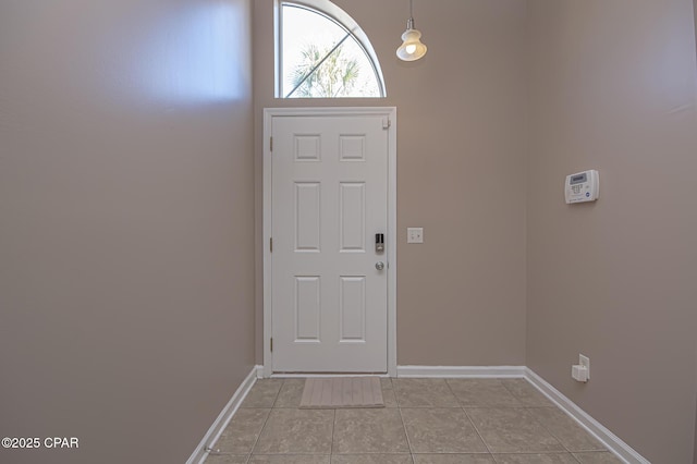 entrance foyer featuring light tile patterned floors and baseboards