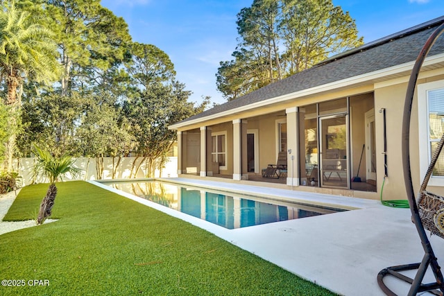 view of pool with a yard and a patio