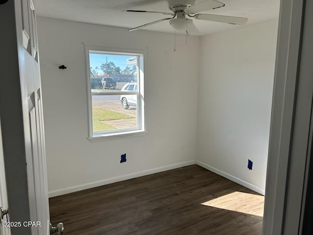 unfurnished room with ceiling fan, a wealth of natural light, and dark hardwood / wood-style flooring