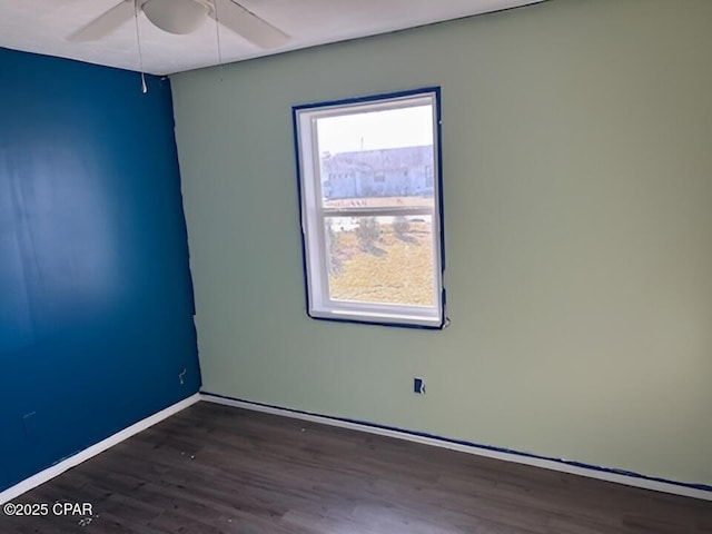 empty room featuring ceiling fan and dark hardwood / wood-style floors