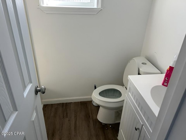 bathroom featuring hardwood / wood-style flooring, toilet, and vanity