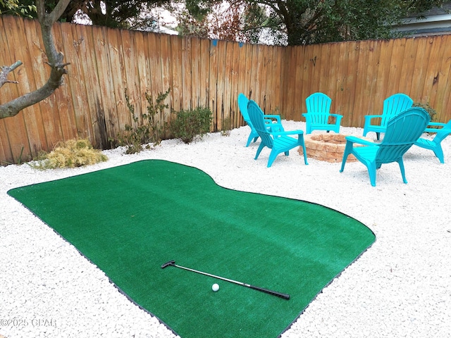 view of yard with a fire pit and fence