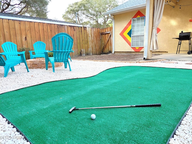 view of jungle gym featuring fence and a patio