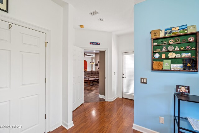 corridor with hardwood / wood-style floors