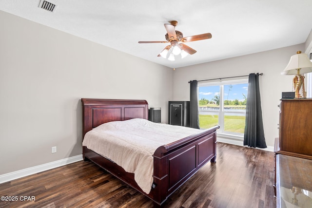 bedroom with ceiling fan and dark wood-type flooring