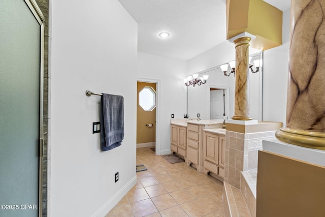 bathroom with tile patterned flooring, vanity, and decorative columns