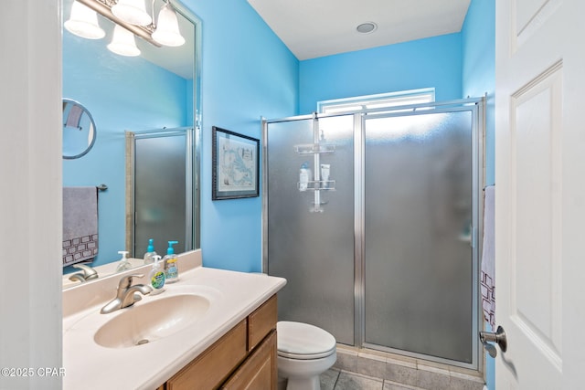 bathroom with tile patterned flooring, vanity, toilet, and an enclosed shower