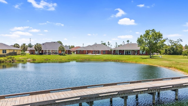 dock area featuring a lawn and a water view