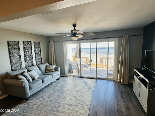 living room with hardwood / wood-style flooring, ceiling fan, and plenty of natural light