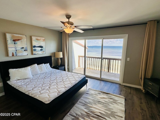 bedroom with access to exterior, a water view, ceiling fan, and dark hardwood / wood-style floors