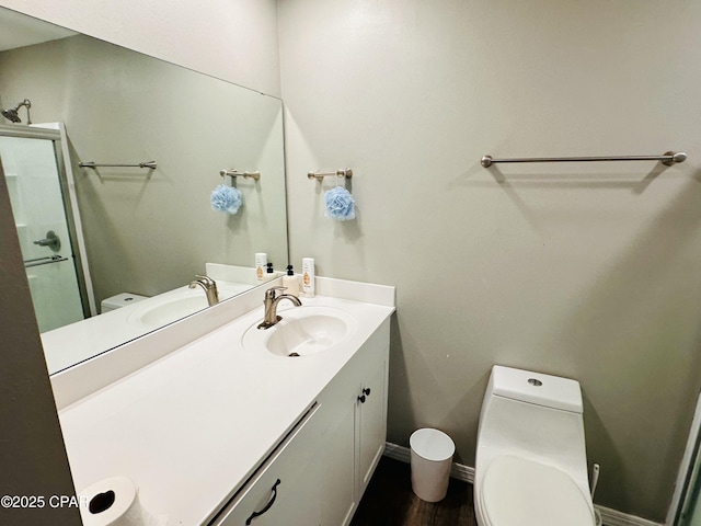 bathroom featuring vanity and toilet