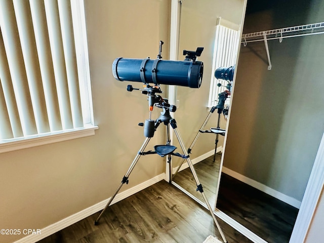 exercise room with hardwood / wood-style flooring