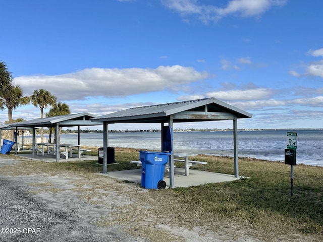 view of dock with a gazebo and a water view