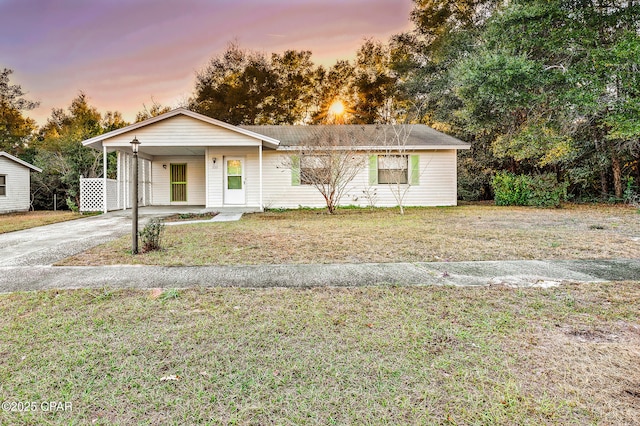 view of front of house with a yard and a carport